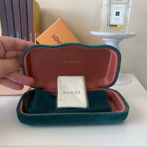 A green Gucci sunglass case